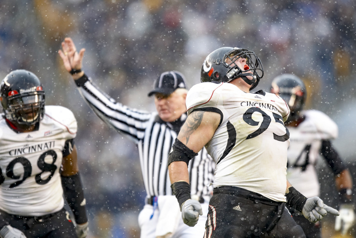 Derek Wolfe celebrates on the field, as a Cincinnati Bearcat.